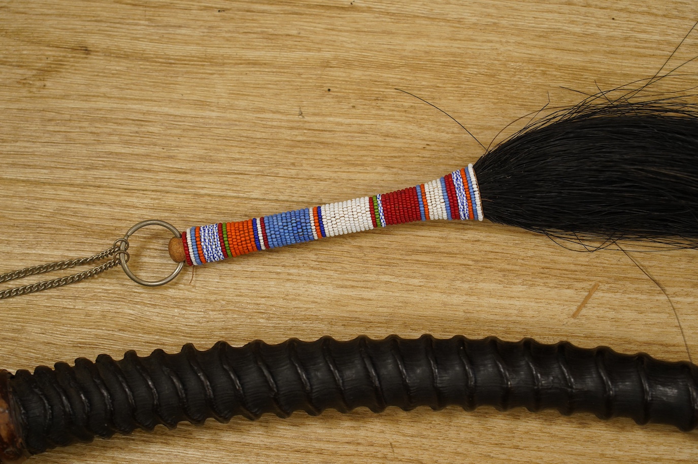 An African antelope horn, 92cm long, and a fly whisk. Condition - fair to good